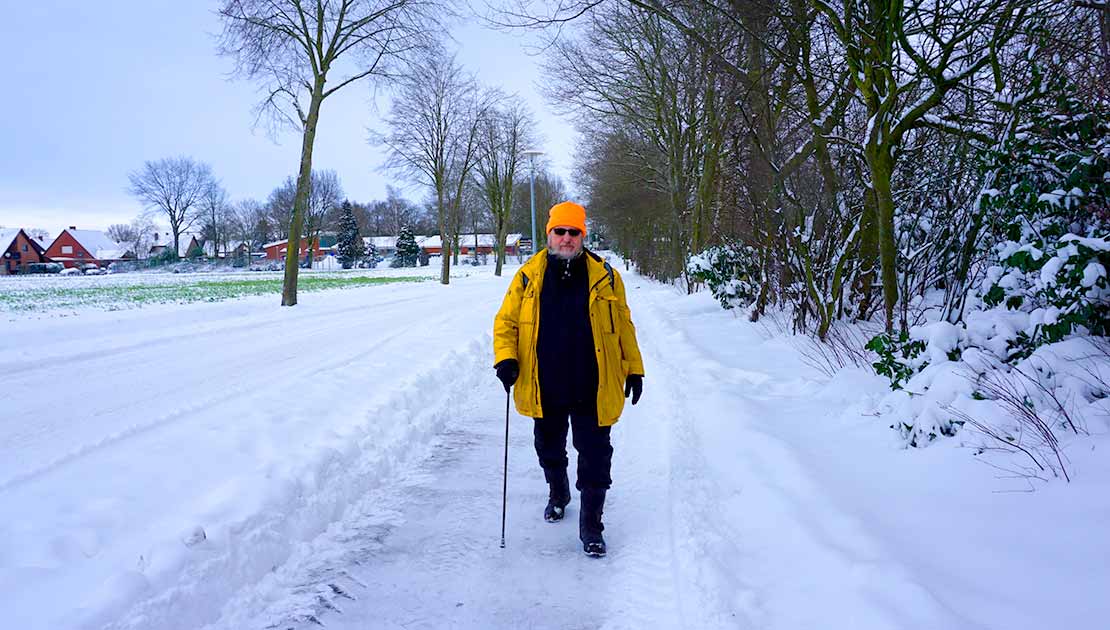 Man walking on snowy sidewalk