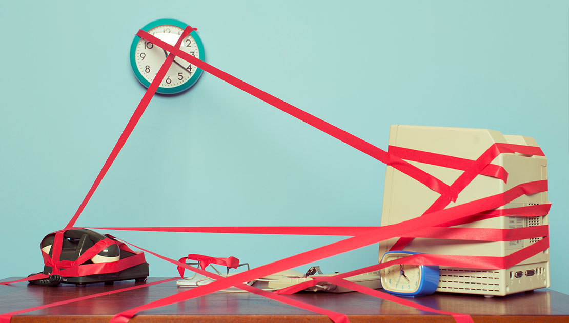 image of red tape around office desk