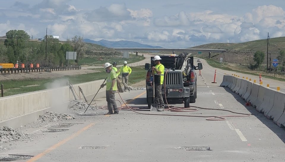 Construction workers on a highway.