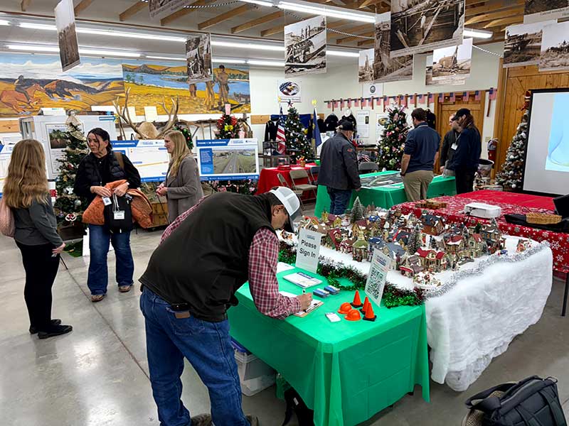 Open house attendees mingle, engage with the project team, and look at visuals of the proposed improvements. 