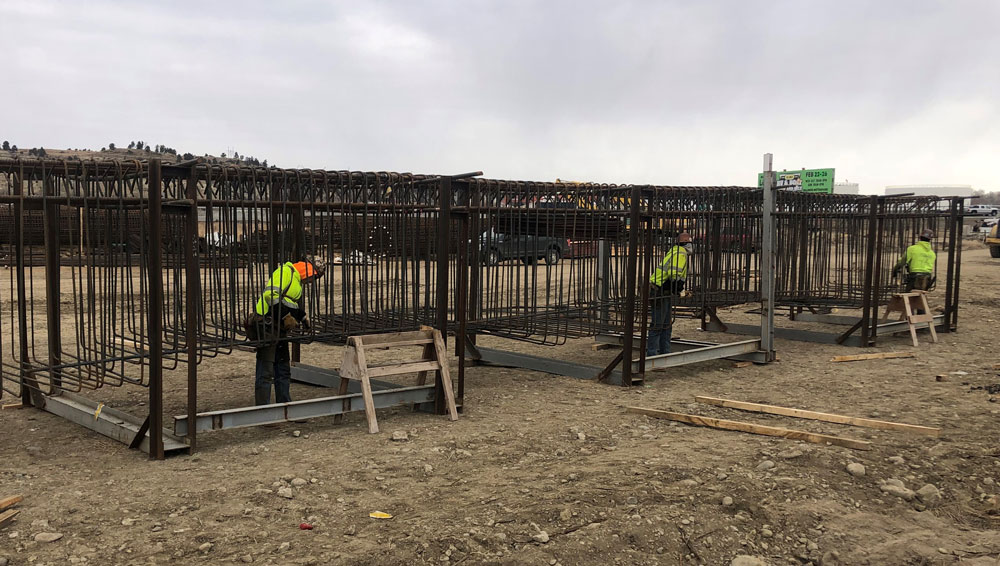 Preassembling the steel reinforcing cages that will be cast in one of the new concrete pier support beams. 