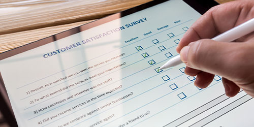 closeup of person filling out a survey on a tablet