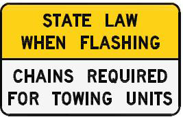 road sign that reads: State law when flashing, chains required for towing units
