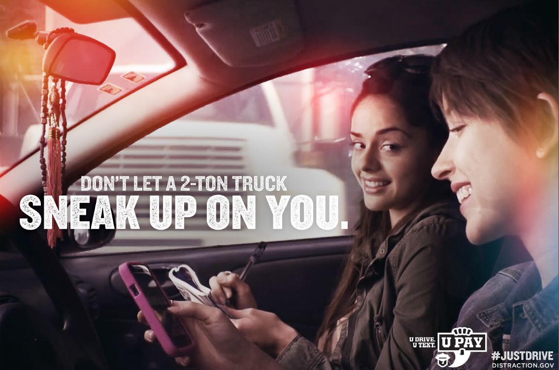 Teens in car with text that says Don't let a 2 ton truck sneak up on you